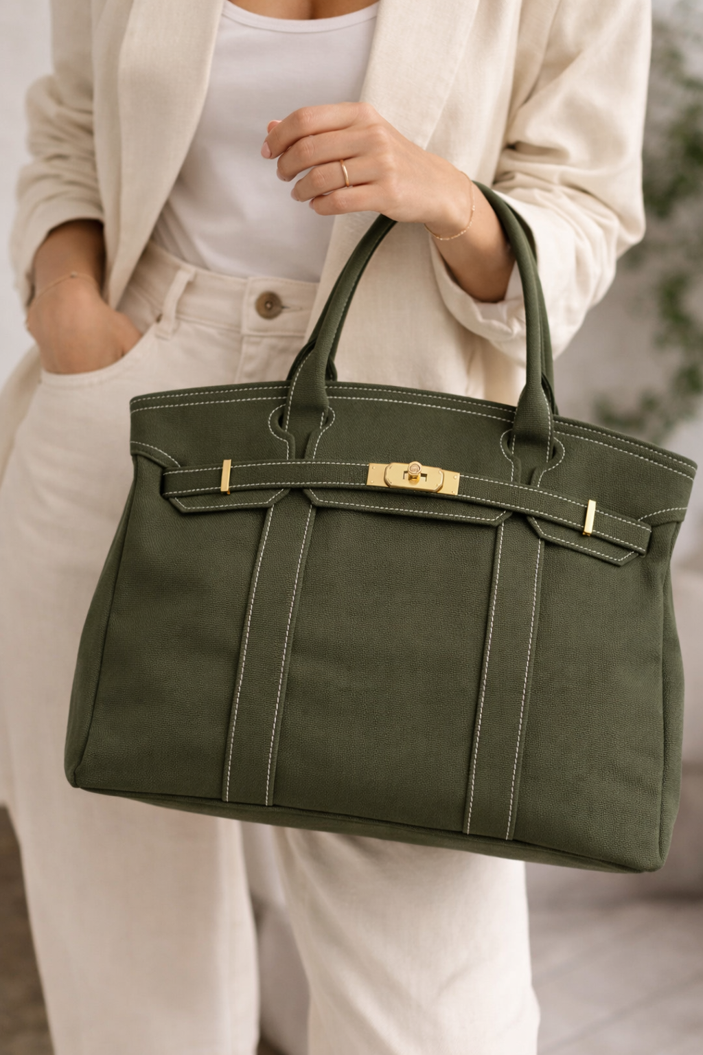 Olive green canvas tote bag carried by model